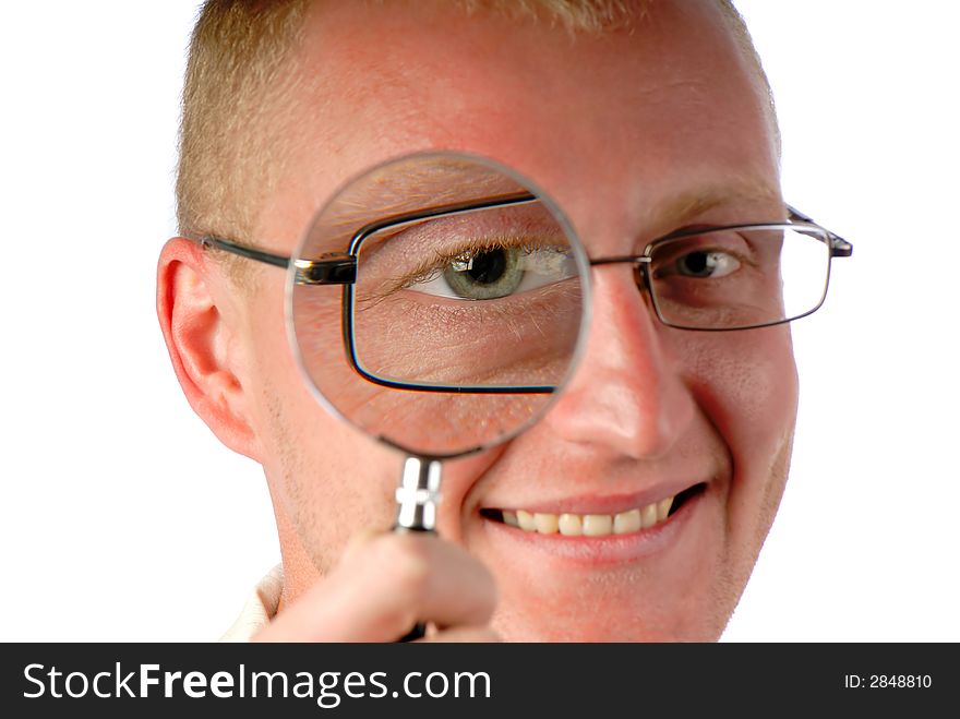 Businessman looks through magnifying glass and smiles