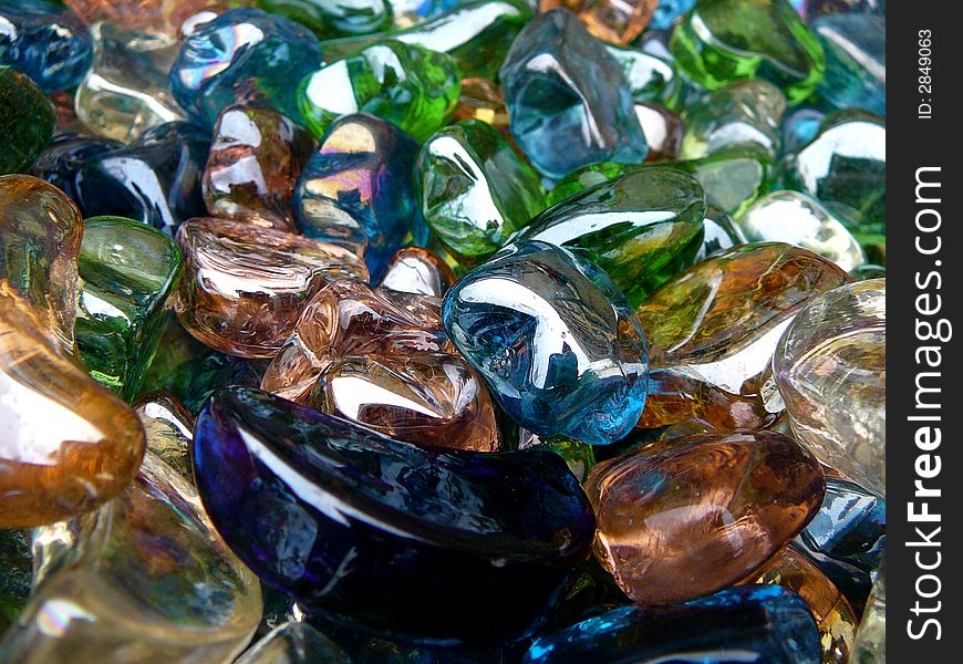 A bin of glass heart, star and moon shapes in various colors.  Foreground contains 3 moon shapes. A bin of glass heart, star and moon shapes in various colors.  Foreground contains 3 moon shapes.