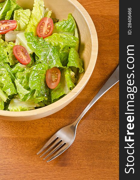 Romaine hearts and grape tomato salad in a wooden bowl #1. Romaine hearts and grape tomato salad in a wooden bowl #1.