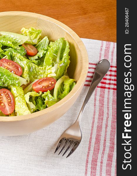 Romaine hearts and grape tomato salad in a wooden bowl #2. Romaine hearts and grape tomato salad in a wooden bowl #2.