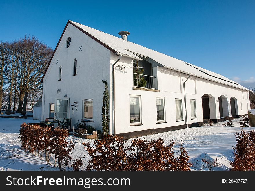 House in the winter with yard and area covered in snow