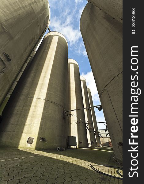 Group of silos on an abandoned terrein of a compound feed factory. The photo was taken with a wide angle lens.