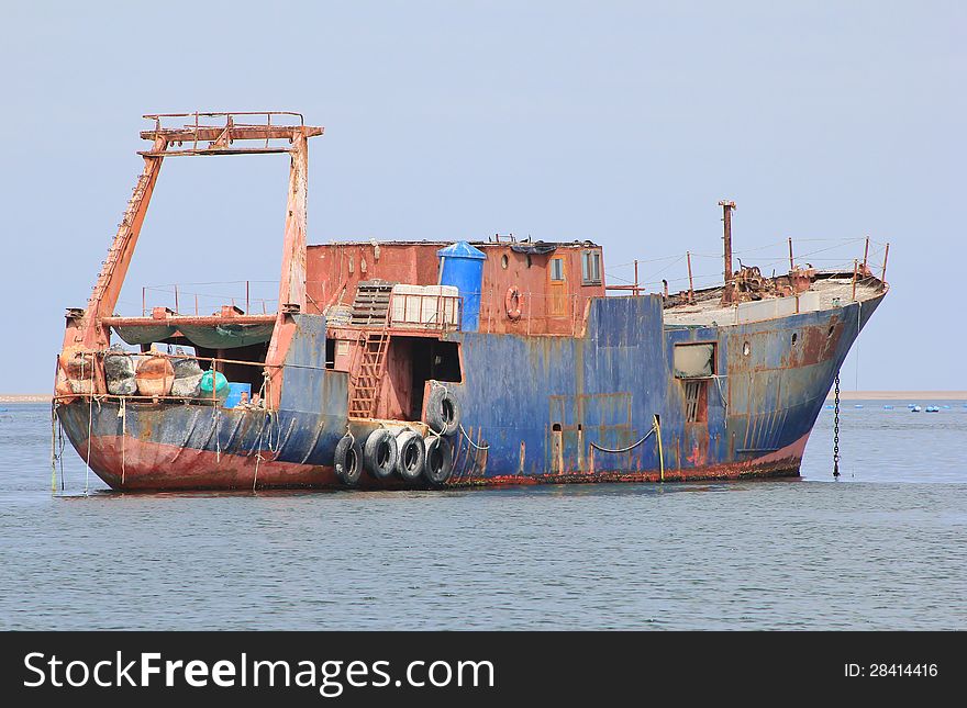 An old, non used ship in the harbour at WalvisBay in Namibia, on the Atlantic Ocean. An old, non used ship in the harbour at WalvisBay in Namibia, on the Atlantic Ocean