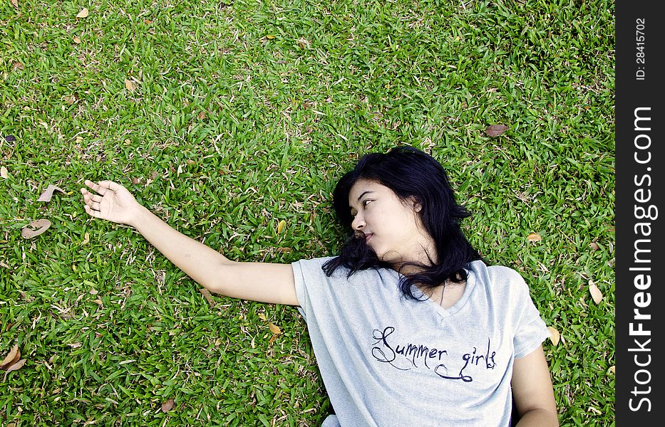 Asian woman laying in the grass