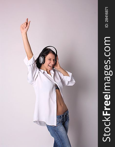 Young woman with headphones on white background