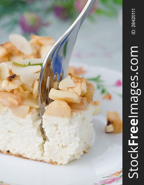 Piece of cottage cheese with apple pie with a fork closeup