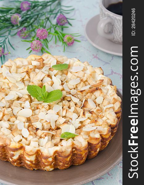 Whole cottage cheese pie with apples, decorated with mint leaf