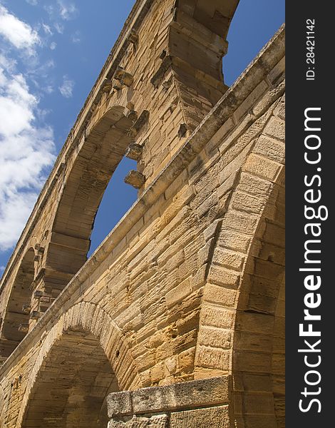 The Pont du Gard is an ancient Roman aqueduct bridge that crosses the Gardon River in southern France. The Pont du Gard is an ancient Roman aqueduct bridge that crosses the Gardon River in southern France