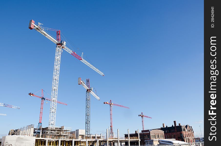 New Condominium construction with cranes under blue sky. New Condominium construction with cranes under blue sky