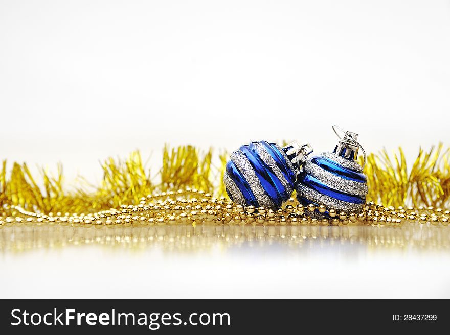 Blue Christmas balls and gold ornaments on a Christmas tree