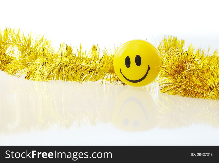 Yellow smile face and gold ornaments. Yellow smile face and gold ornaments