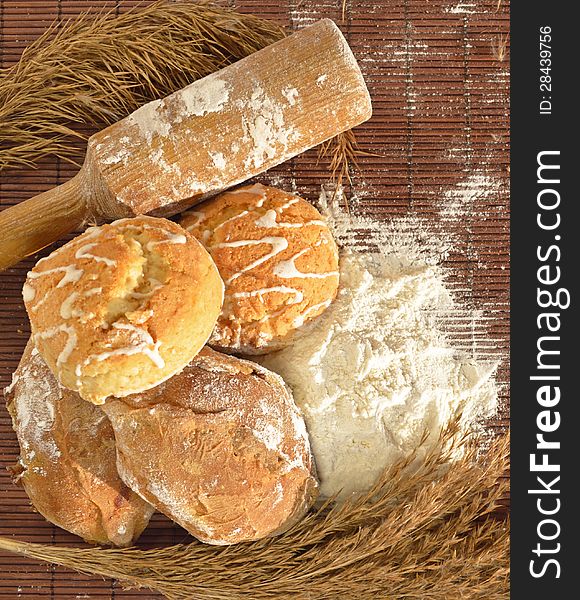 A pile of home baked ginger cakes with rolling pin and wheat flour. A pile of home baked ginger cakes with rolling pin and wheat flour