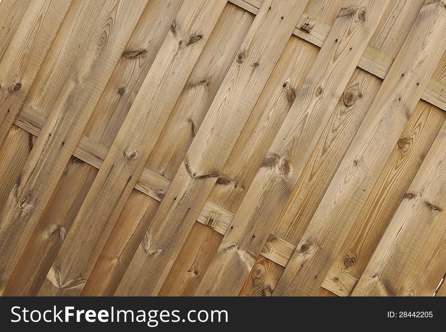 Slats of a wooden panel (pine) forming a background. Slats of a wooden panel (pine) forming a background