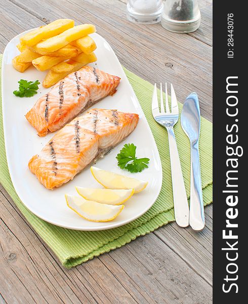 Grilled salmon fillets with chips. Grilled salmon fillets with chips