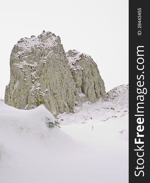 Mountains with large rock formations under snow in the middle of the winter. Mountains with large rock formations under snow in the middle of the winter.