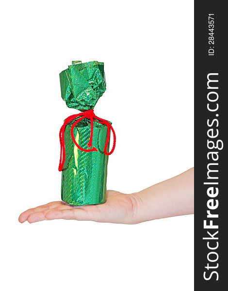 Holiday gift in bright green packaging on a female hand