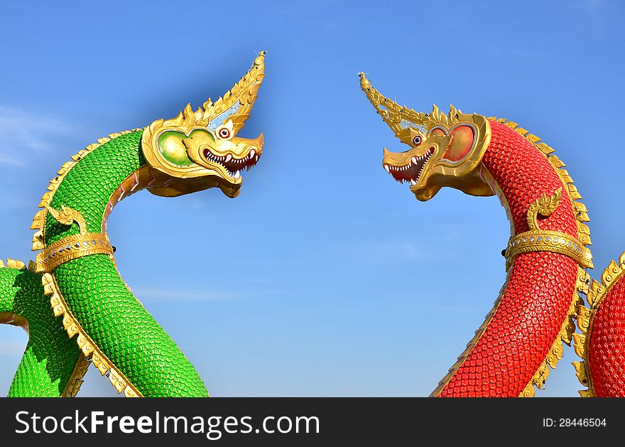 Big green and red serpents staue in temple of Thailand