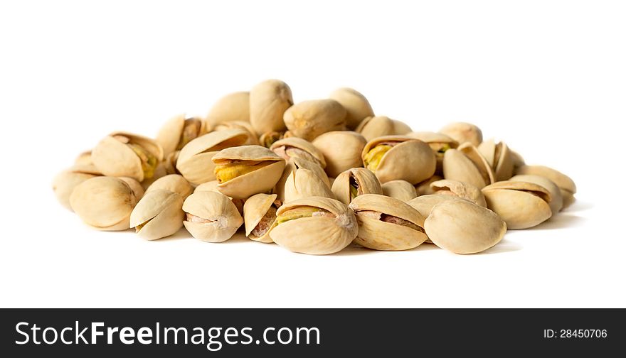 Delicious cracked pistachio nuts isolated on white background