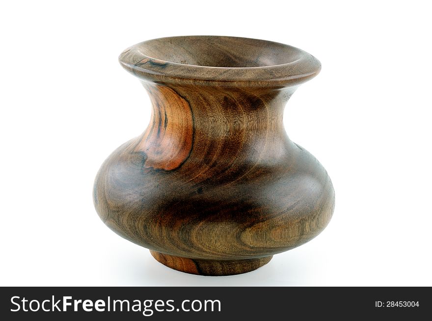 Wooden carved vase carved from wood and photographed against a white background. Wooden carved vase carved from wood and photographed against a white background