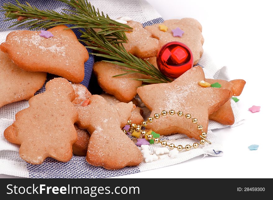 Gingerbread Christmas Cookies decorated with Colorful Candy, Sugar Powder and Fir closeup on Napkin
