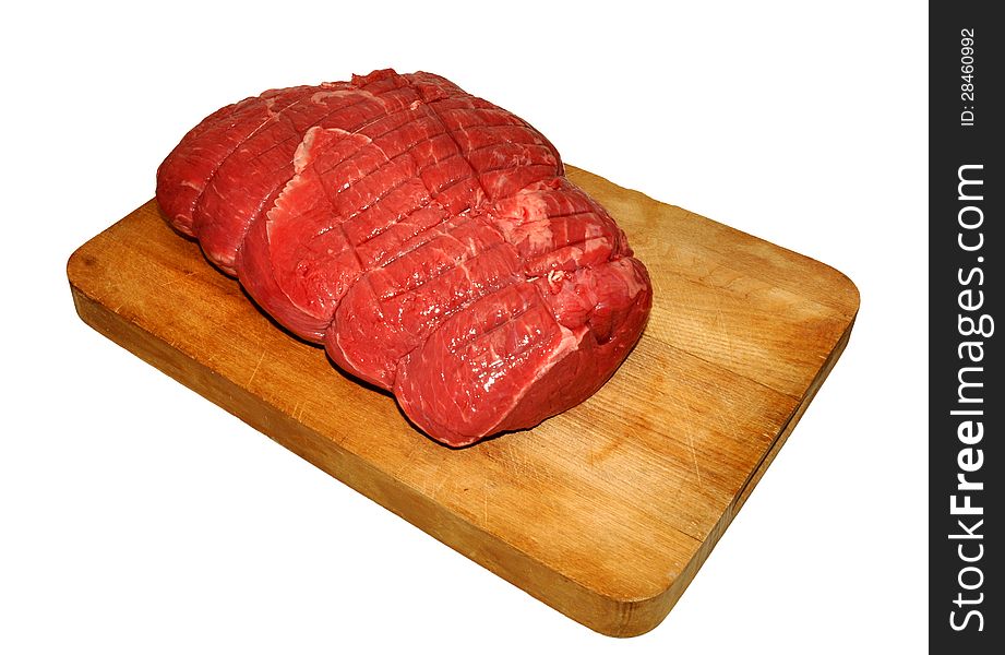 Raw uncooked beef on wooden chopping board. Raw uncooked beef on wooden chopping board