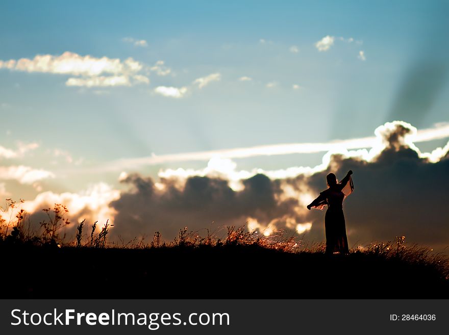 Silhouette of a girl in the sunset