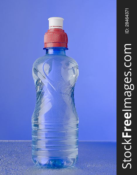 Bottle of water over blue background