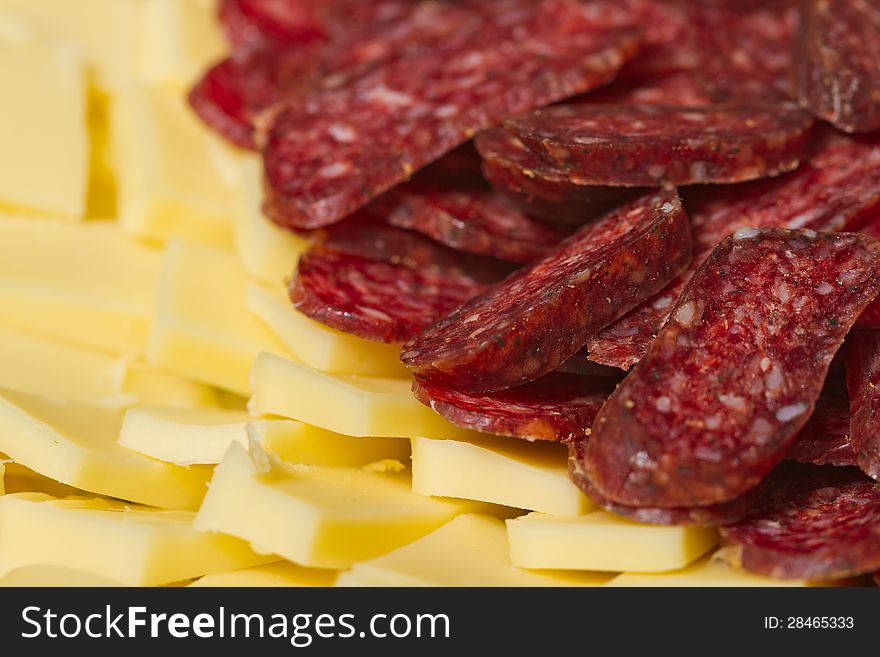 Sliced meat appetizers and cheese in plate