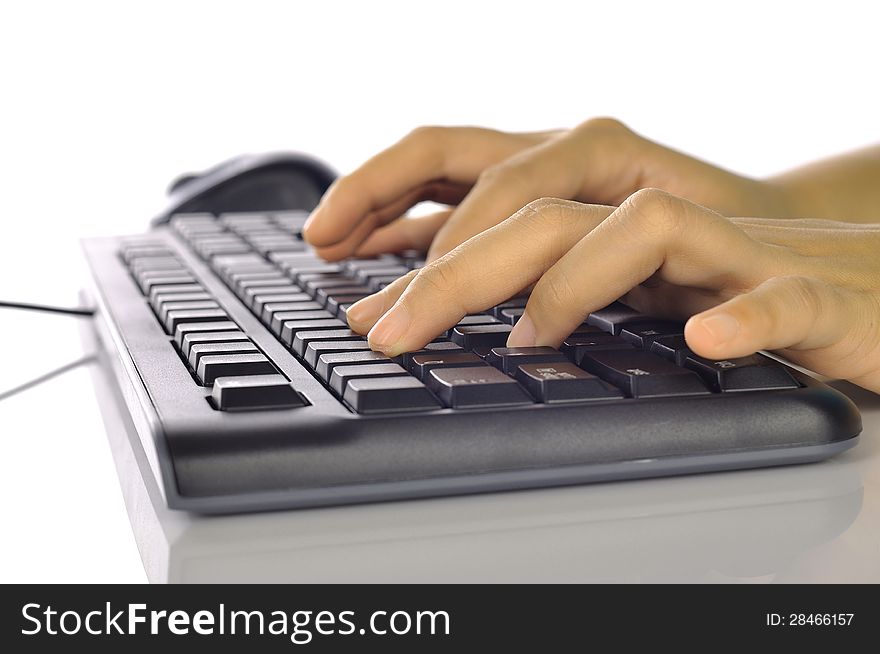 Woman hand typing on black computer keyboard isolated over white background. Woman hand typing on black computer keyboard isolated over white background