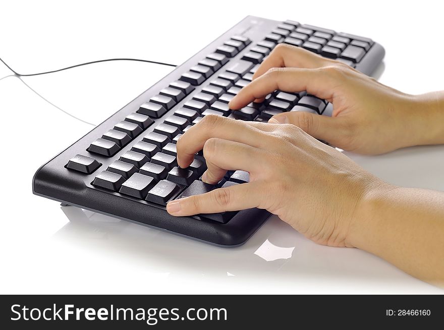 Woman hand typing on black computer keyboard over white background. Woman hand typing on black computer keyboard over white background
