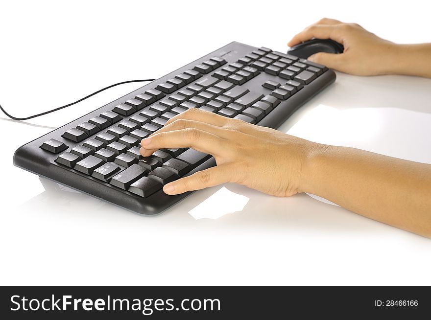 Woman hand typing on black computer keyboard over white background. Woman hand typing on black computer keyboard over white background