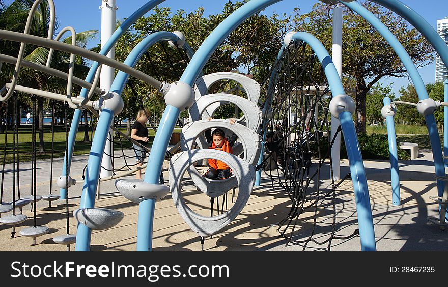 Little boy playing on the playground in South Pointe Park Miami Beach, Florida. Little boy playing on the playground in South Pointe Park Miami Beach, Florida