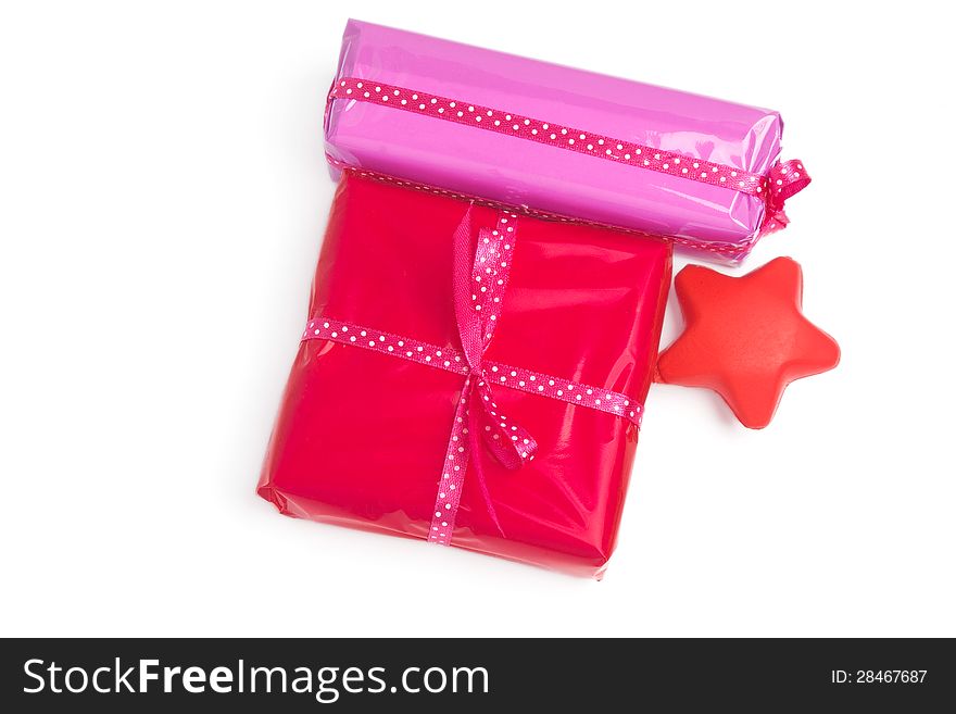 Set of red and pink wrapped gifts and a decoration star (with light shadow). Set of red and pink wrapped gifts and a decoration star (with light shadow)