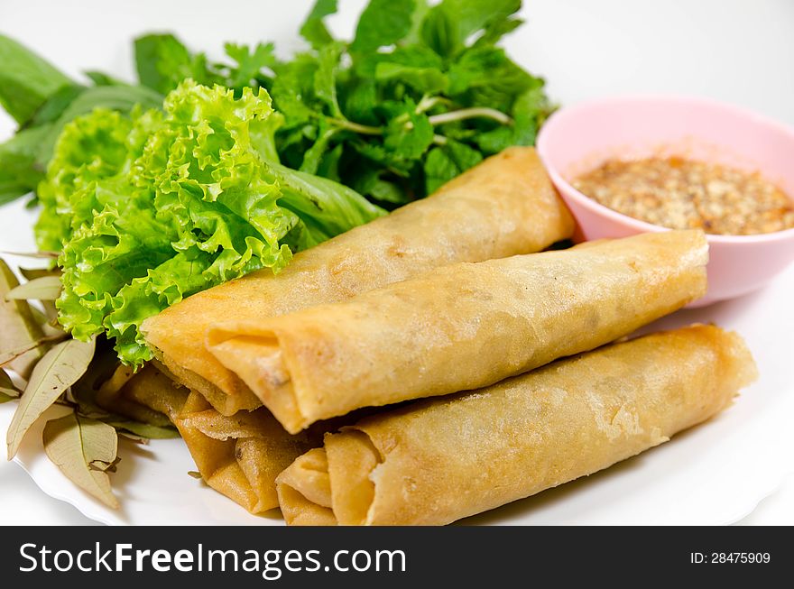 Crispy spring rolls on dish with vegetable