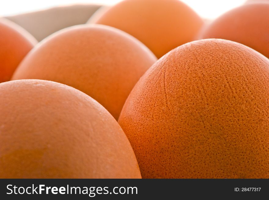 Close up on two raw eggs, one broken, one whole  on white background. Close up on two raw eggs, one broken, one whole  on white background