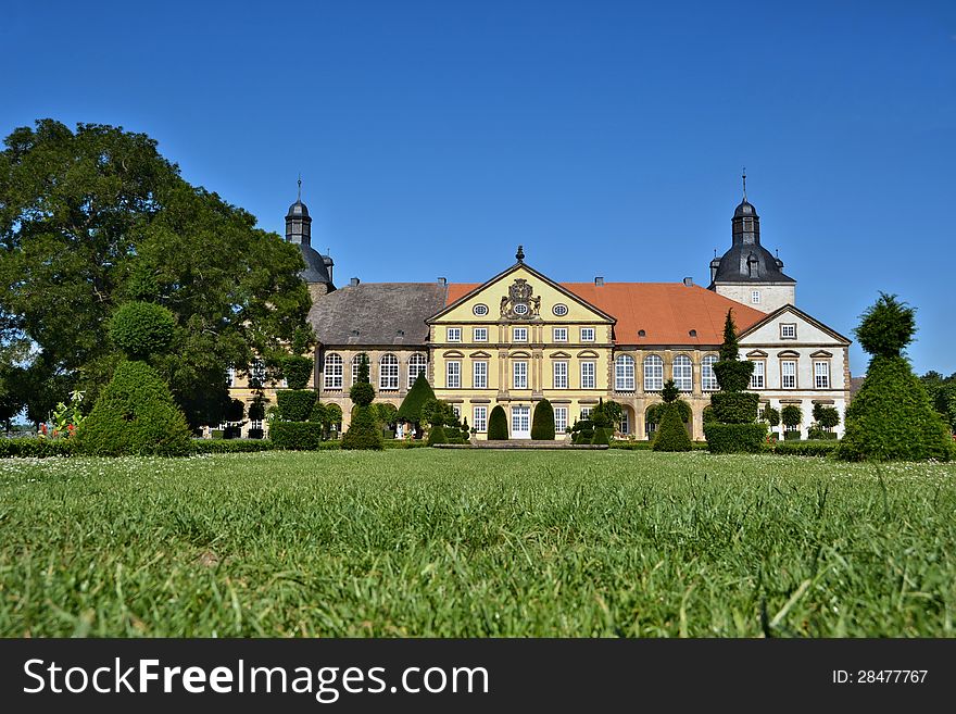 Historic baroque castle in Hundisburg with trees and well-kept lawn. Historic baroque castle in Hundisburg with trees and well-kept lawn