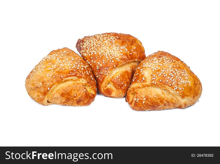 Pies from flaky pastry strewed with sesame seeds. Pies from flaky pastry strewed with sesame seeds