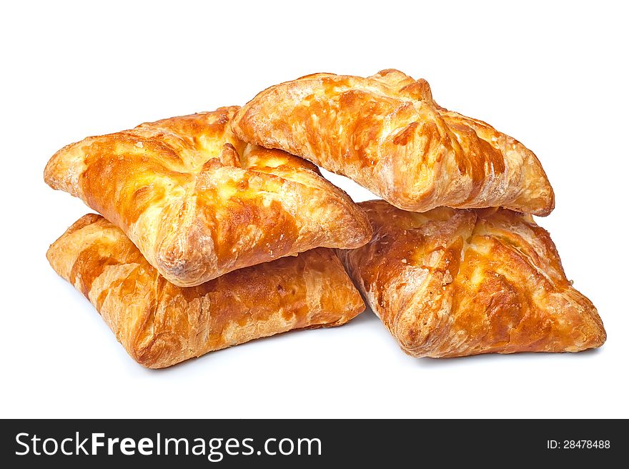 Four pies from flaky pastry on a white background