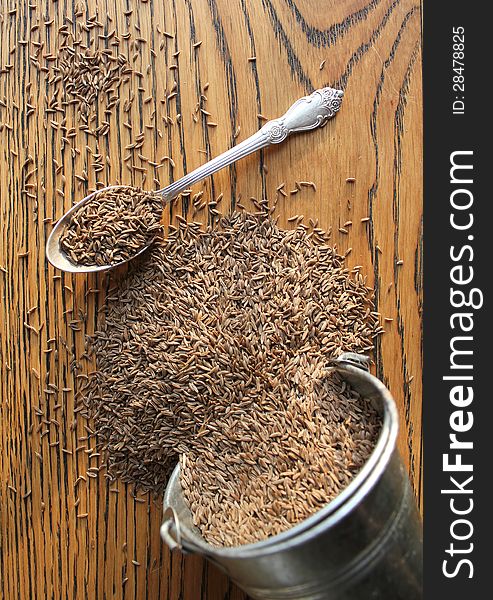 Cumin seeds on wooden background