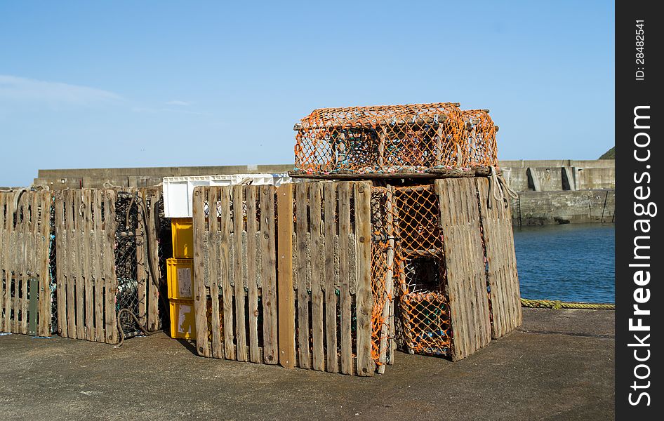 Lobster pots stacked on pier in Scotland