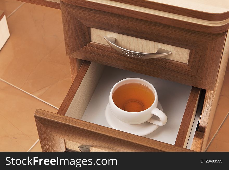 Cup Of Tea In Desk Drawer