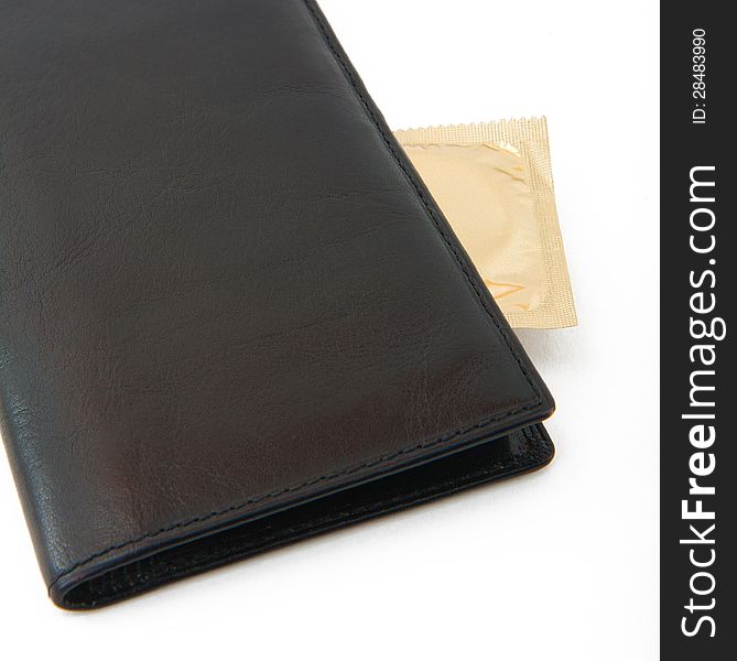 Condom in black wallet isolated