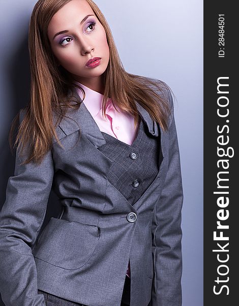 Trendy Woman in Blue - Grey Suit posing. Trendy Woman in Blue - Grey Suit posing