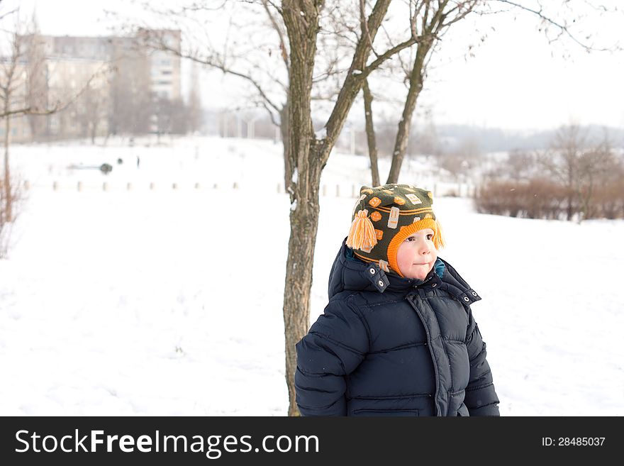 Small Boy Outdoors In Winter Snow