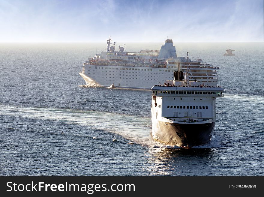 Merchant ship entering port and cruise leaving it. Merchant ship entering port and cruise leaving it.