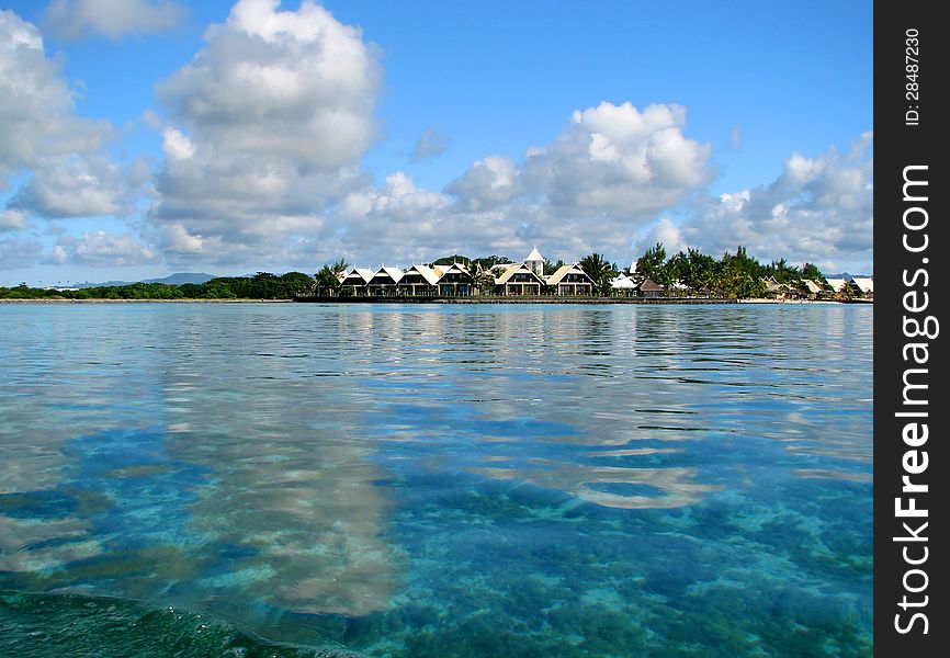 Small island in the smaragd lagoon with small houses. Small island in the smaragd lagoon with small houses.