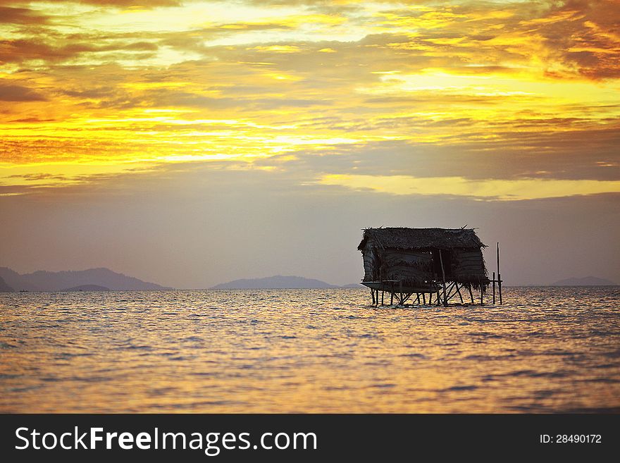 House on wooden stilts in the middle of the ocean during summertime