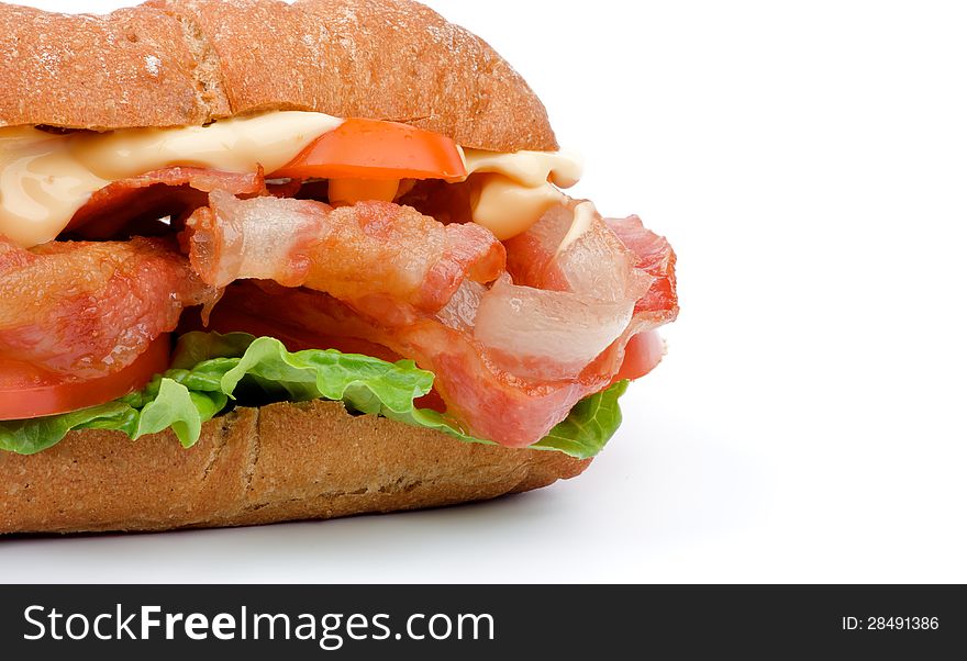 Tasty Ciabatta Sandwich with Bacon, Tomato, Lettuce, Cheese and Sauces closeup on white background. Tasty Ciabatta Sandwich with Bacon, Tomato, Lettuce, Cheese and Sauces closeup on white background