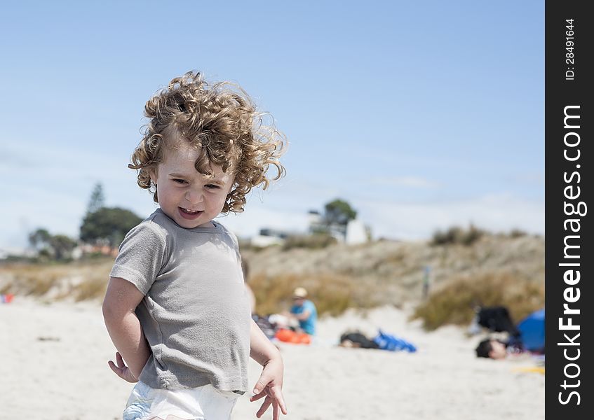 Small boy enjoying day at the beach, laughing,and happy. Small boy enjoying day at the beach, laughing,and happy.