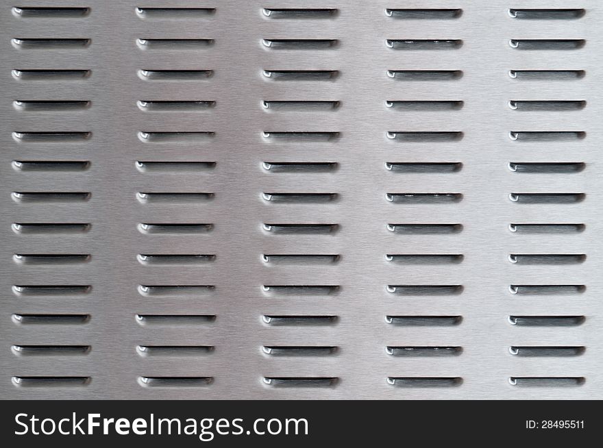 Perforated brushed metal surface background. Perforated brushed metal surface background
